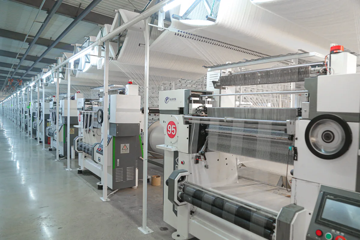 Crochet machines in operation with yarn feeding overhead