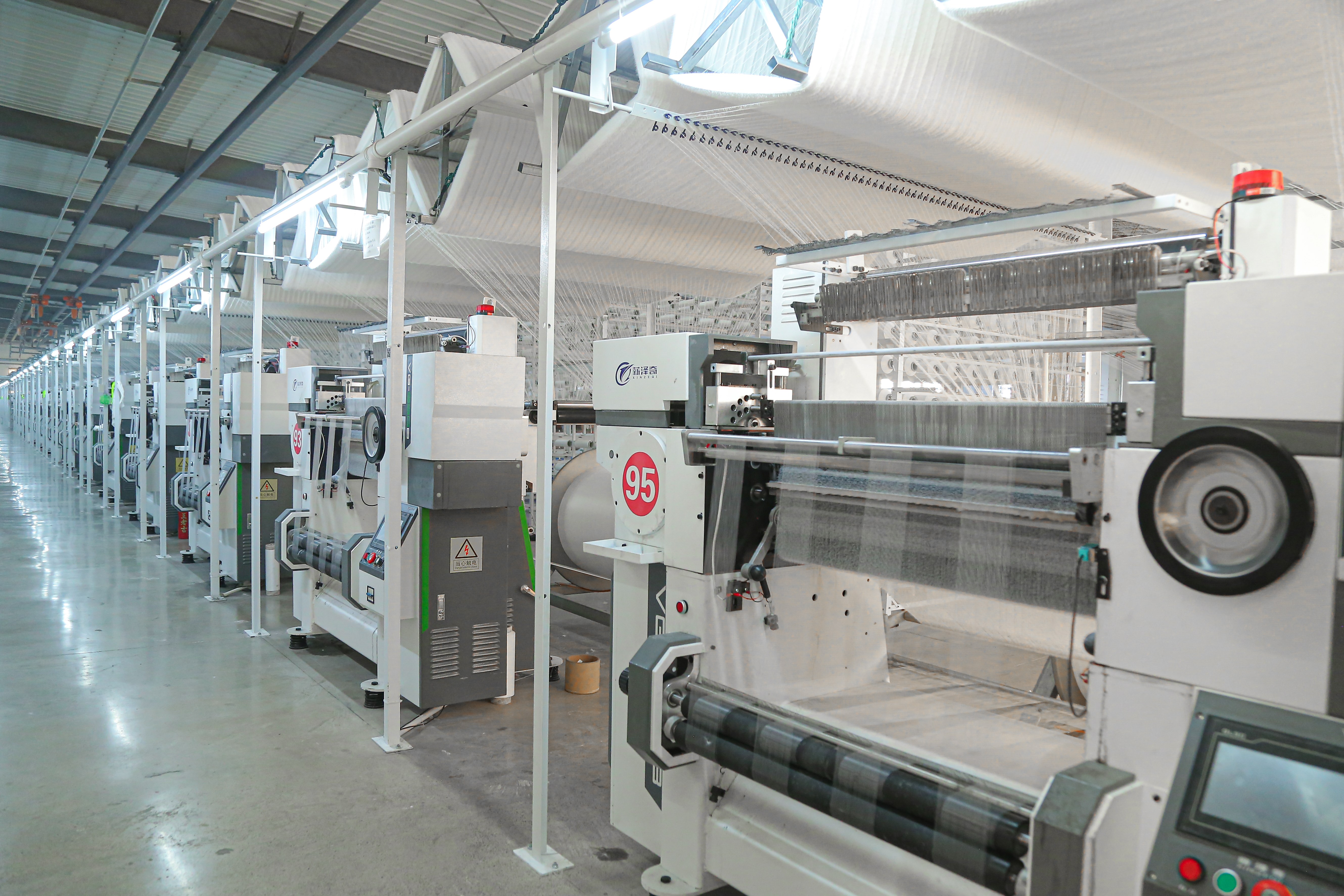 Crochet machines in operation with yarn feeding overhead